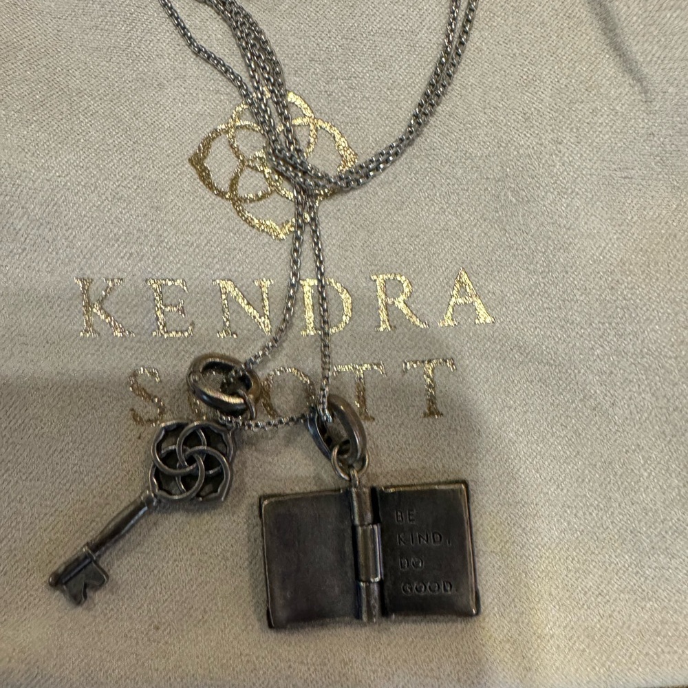 Kendra Scott Silver Charm Necklace. Adjustable Length with key and book charm.